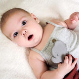 Baby lying holding an organic rubber elephant teether soother blankets