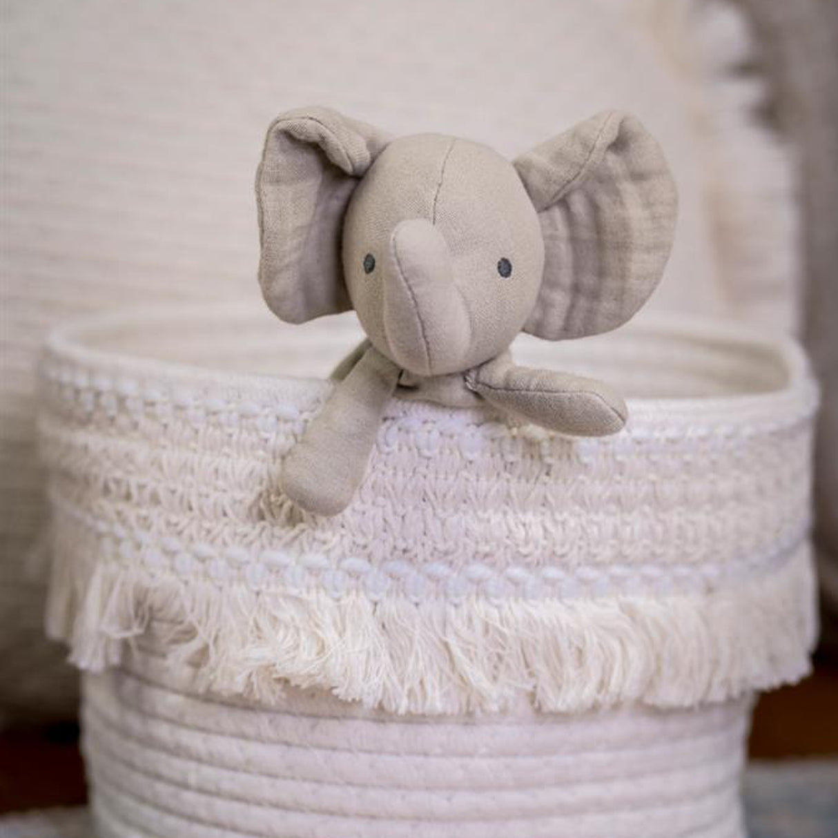 Elephant baby toy in a cloth white basket