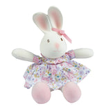 Stuffed rubber bunny toy with a floral dress on a white background