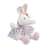 Plush rubber rabbit toy with a floral dress on a white background