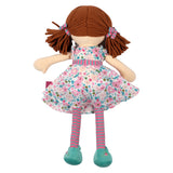 Soft rag doll with brown hair with pigtails wearing a floral pink and turquoise dress, stripey tights and turquoise shoes from the back