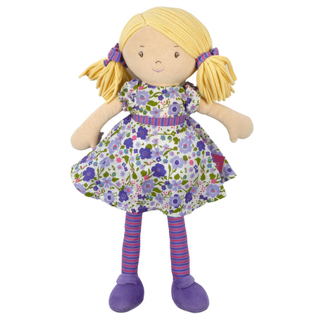 Soft rag doll with blonde hair, purple and green floral dress, and striped leggings on a white background