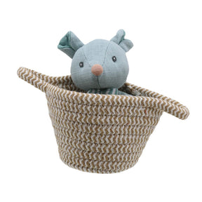 A soft toy mouse in a woven basket, primarily in shades of beige and cream with a soft fabric finish.