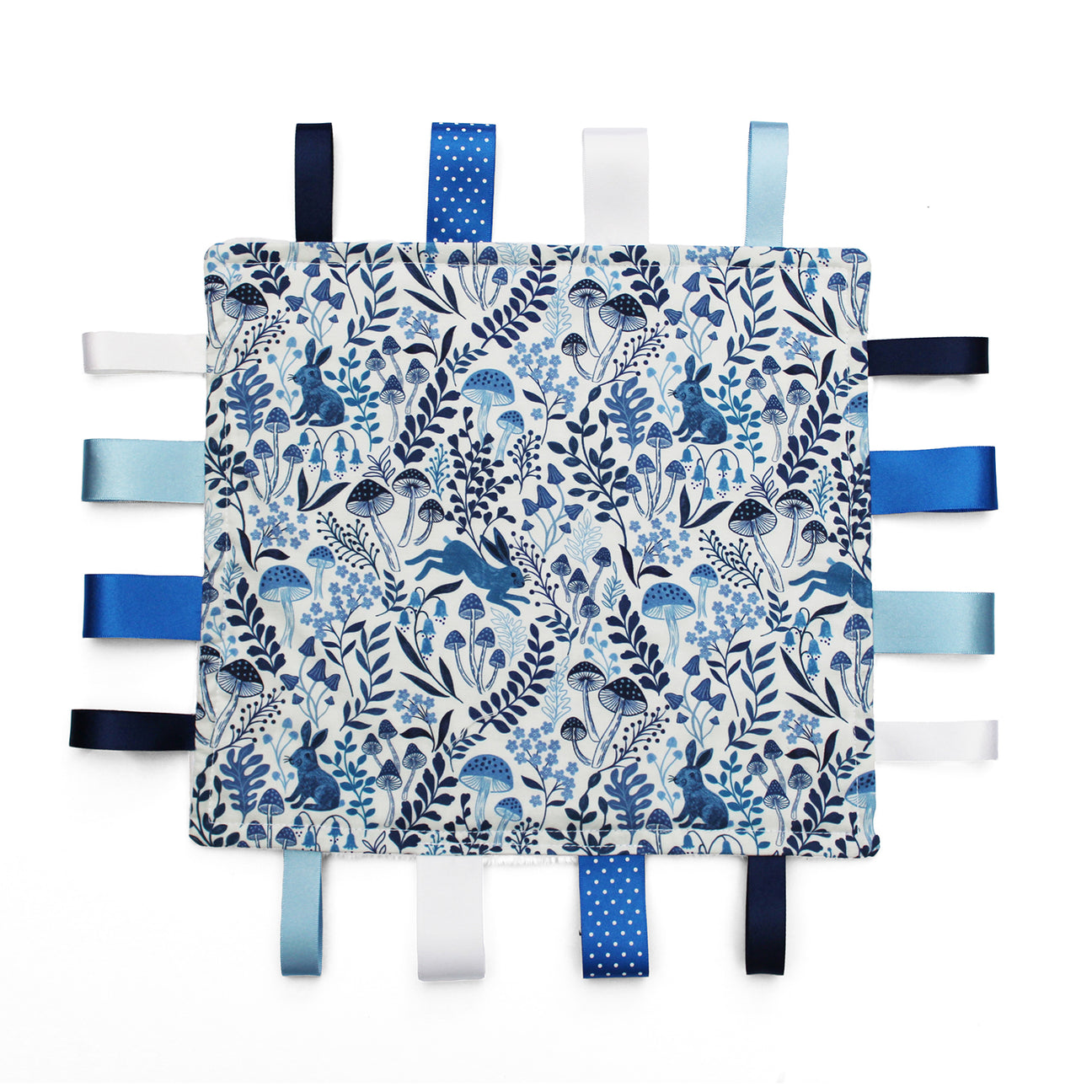 Fabric taggy blanket with blue rabbit woodland pattern and colourful ribbon tags on a white background