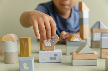 Building blocks of wood being stacked