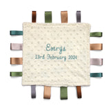 Baby comfort blanket with embroidered name and date on a white background