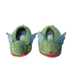 A pair of hand crocheted green baby booties with a dragon design, including a grey wings and a sticking out tongue.