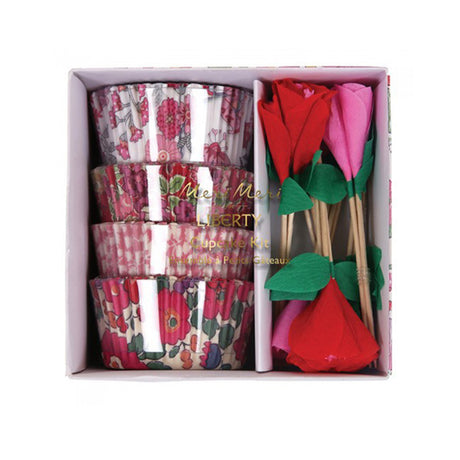 A set of floral design cases with pink and red flower toppers for cupcakes, presented in a box.