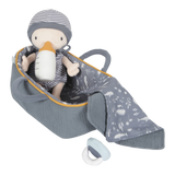 A soft plush baby doll named Jim sitting in a carry basket with a blanket and bottle, all in gray tones with yellow accents.