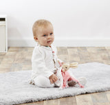 Baby holding a  white and pink Beatrix Potter Flopsy Bunny Comforter that can be personalised