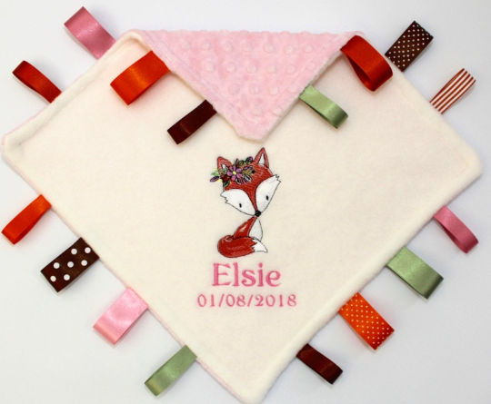 A Floral Fox Taggy Baby Comforter with colourful satin ribbons  