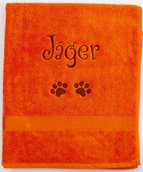 A large orange personalised Dog Towel with name and dog paws