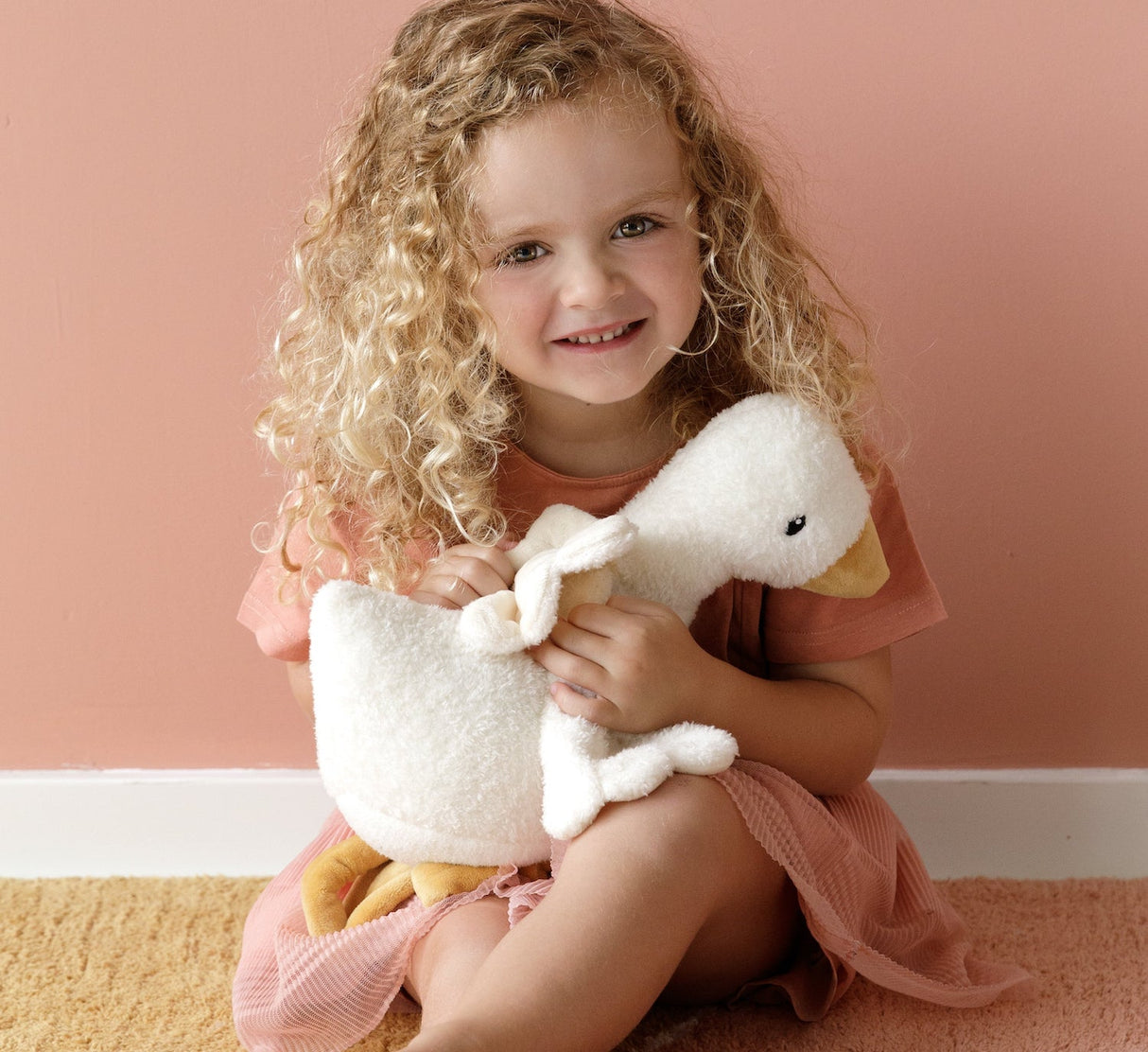 Large Little Goose cuddly toy by Little Dutch showing soft plush texture held by girl in pink room