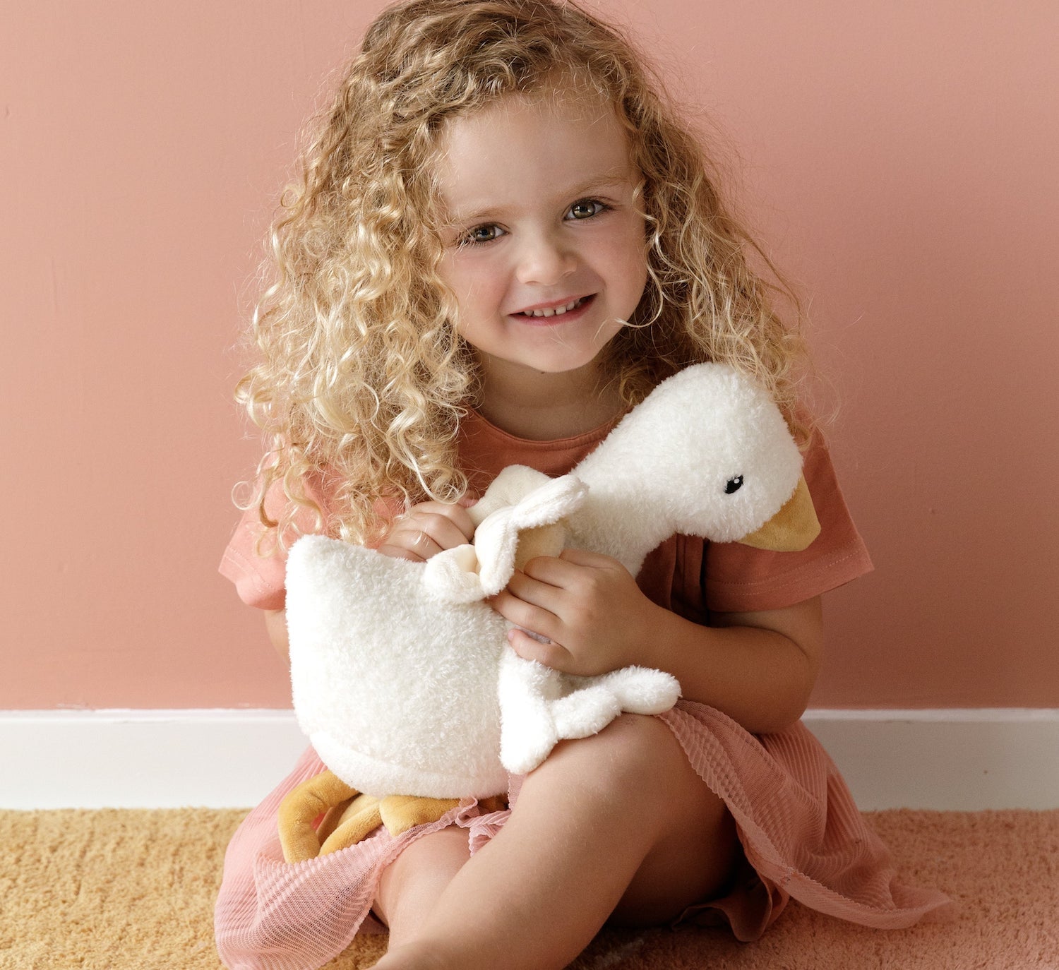 Large Little Goose cuddly toy by Little Dutch showing soft plush texture held by girl in pink room