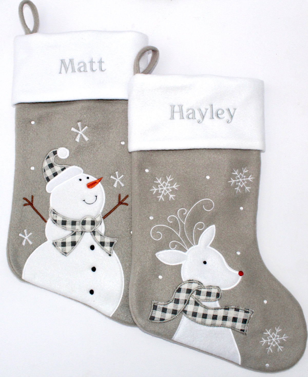 Two personalised grey Christmas Stockings with snowman, deer and embroidered names above
