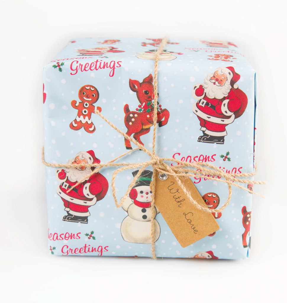 Close up of Beautiful Vintage Christmas Santa Wrapping Paper with Santa, Snowman and reindeer on blue paper. Ideal for Christmas, Birthdays and Christenings