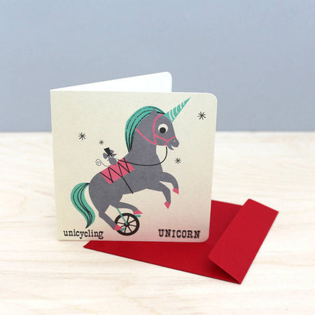 Noodoll retro style unicycling unicorn child or baby greeting card in a nostalgic flash learning cards design