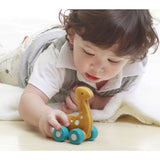 child playing with a plan toys eco friendly car