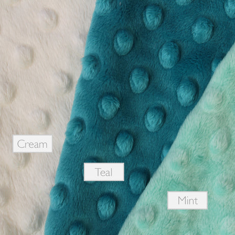 Selection of the rear dimble of a lovely unique handmade Baby Taggy comforter which can be personalised. Professionally made using 'Dinosaur' fabric