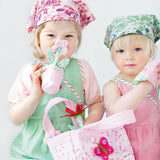 Two Children playing with oskar and ellen childrens fabric gardening set toy pink basket watering can