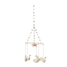 Petit Pehr mobile has five swans hanging above and a pink lily in the centre