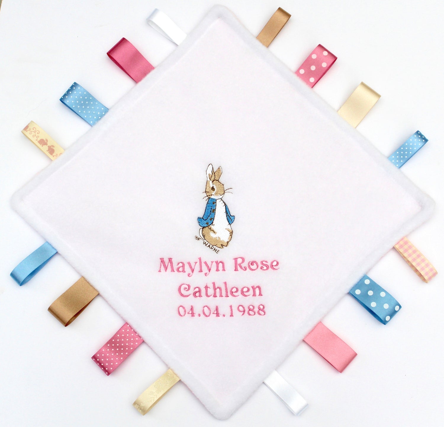 Beatrix Potter Peter Rabbit Taggy with blue and pink ribbons