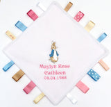 Beatrix Potter Peter Rabbit Taggy with blue and pink ribbons