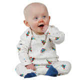 Lovely baby wearing a lovely footed playsuit, also known as a romper, featuring Rockets and stars in grey from Piccalilly Organics
