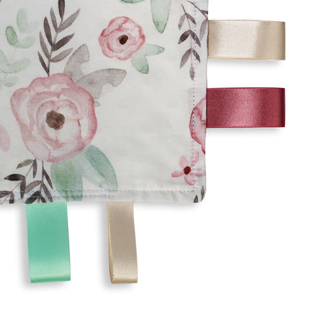 Close up view of a lovely unique eco friendly handmade Baby Taggy comforter Professionally made using 'Wild Rose' fabric