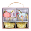 A set of gold foil cupcake cases with unicorn and rainbow toppers, presented in a box with a pink ribbon handle. The toppers include pink and white unicorns with thread tails and a 'I Believe In Unicorns' sign.