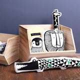 Wee Gallery Crocodile Cushion displayed next to other Wee Gallery cushions